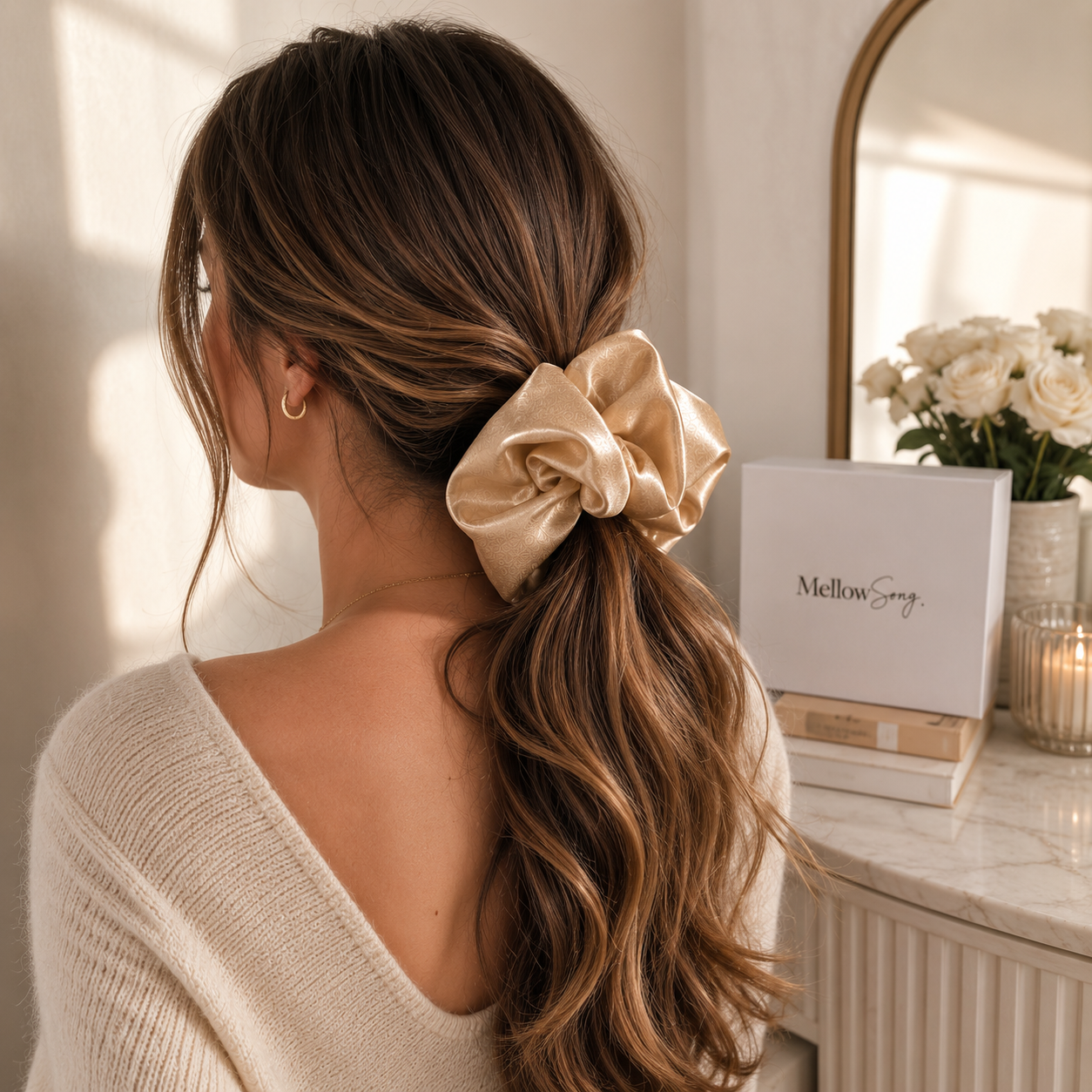 Woman showcasing a champagne silk grand beige scrunchie hair accessory