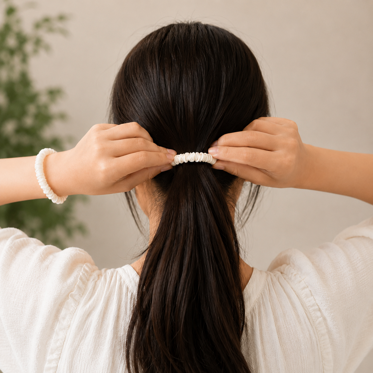Woman showcasing a champagne silk white scrunchie hair accessory