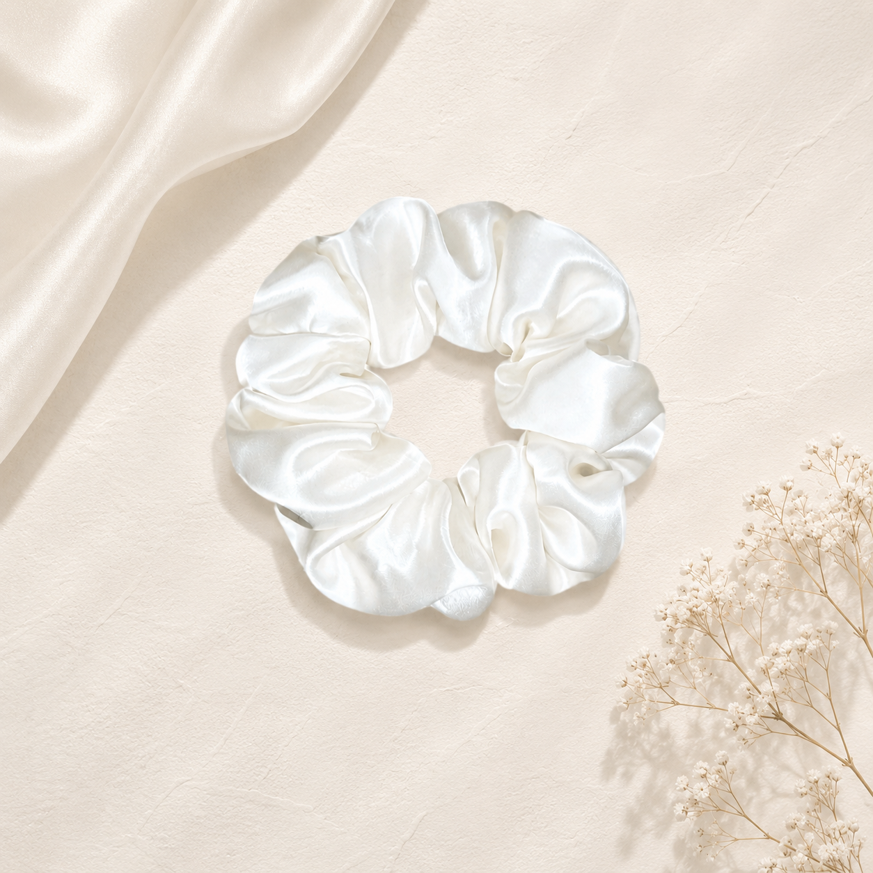 Luxury silk classic white scrunchie displayed on a soft satin background