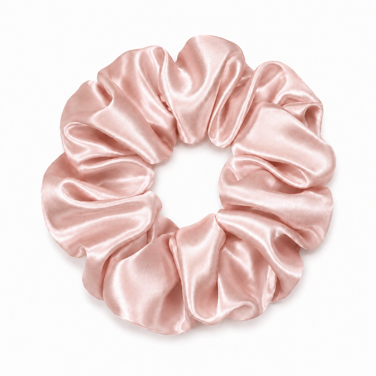 Champagne 22 momme silk grant pink scrunchie arranged on a surface