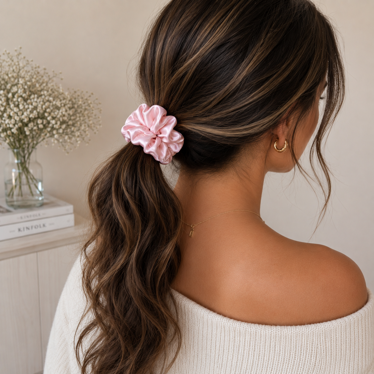 Woman wearing a champagne classic pink scrunchie in a low ponytail hairstyle